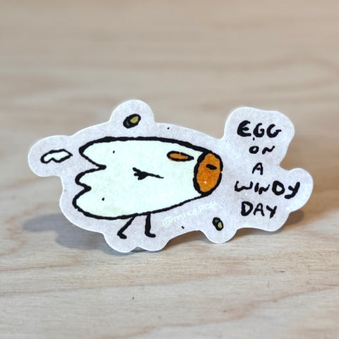Egg on a Windy Day Sticker by @mikepop